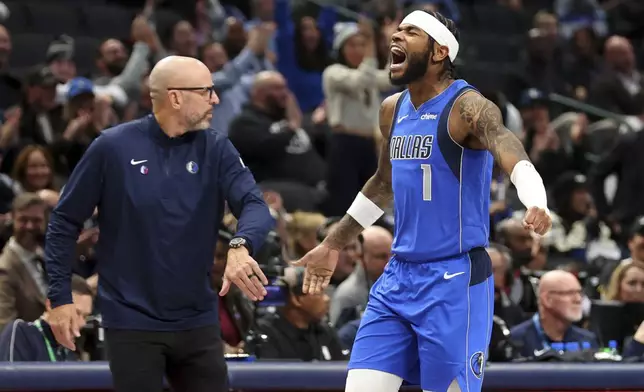 Dallas Mavericks' Jaden Hardy celebrates with head coach Jason Kidd after a three-pointer against the Portland Trail Blazers in the first half of an NBA basketball game, Thursday, Jan. 9, 2025, in Dallas. (AP Photo/Richard W. Rodriguez)