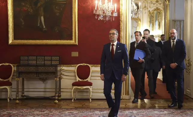 Head of the Freedom Party (FPOe) Herbert Kickl, center, arrives at the presidential office, in Vienna, Austria, Monday, Jan. 06, 2025. (AP Photo/Heinz-Peter Bader)