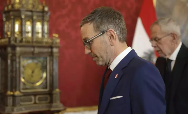 Austrian Freedom Party leader Herbert Kickl, center, arrives next to Austrian President Alexander Van der Bellen at the presidential office, in Vienna, Austria, Monday, Jan. 06, 2025. (AP Photo/Heinz-Peter Bader)