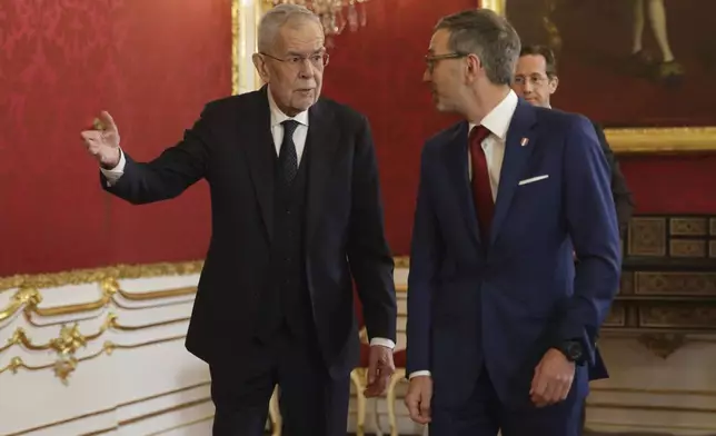 Austrian President Alexander Van der Bellen, left, welcomes head of the Freedom Party (FPOe) Herbert Kickl at his office, in Vienna, Austria, Monday, Jan. 6, 2025. (AP Photo/Heinz-Peter Bader)