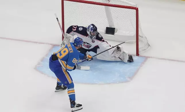 Columbus Blue Jackets goaltender Jet Greaves (73) stops a shot from St. Louis Blues' Pavel Buchnevich (89) during the third period of an NHL hockey game Saturday, Jan. 11, 2025, in St. Louis. (AP Photo/Jeff Roberson)