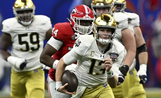 FILE - Notre Dame quarterback Riley Leonard (13) scrambles up field during the first half against Georgia in the quarterfinals of a College Football Playoff, Thursday, Jan. 2, 2025, in New Orleans. (AP Photo/Matthew Hinton, File)