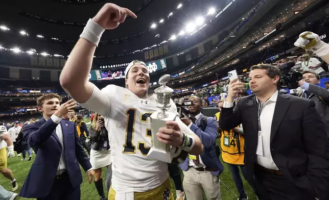 FILE- Notre Dame quarterback Riley Leonard (13) celebrates after a quarterfinal game against Georgia in the College Football Playoff, Thursday, Jan. 2, 2025, in New Orleans. (AP Photo/Gerald Herbert, File)