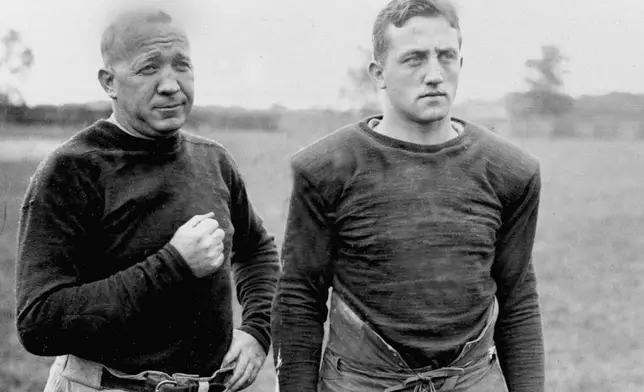 FILE - Notre Dame football coach Knute Rockne, left, and team captain Clem Crowe watch the team practice in 1925. (AP Photo/File)