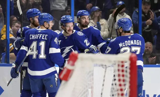 Tampa Bay Lightning center Michael Eyssimont (23) celebrates his goal against the Boston Bruins with teammates, including right wing Mitchell Chaffee (41) and defenseman Ryan McDonagh (27) during the second period of an NHL hockey game Thursday, Jan. 9, 2025, in Tampa, Fla. (AP Photo/Chris O'Meara)