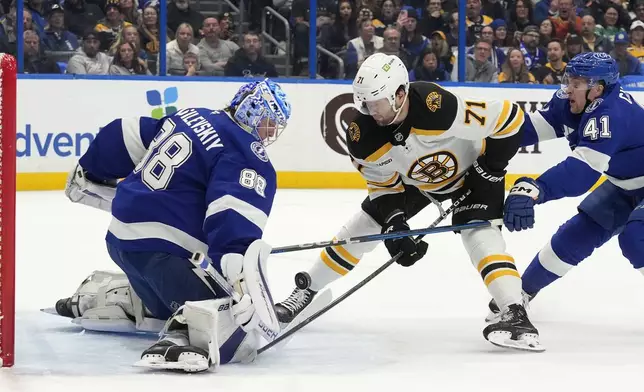 Tampa Bay Lightning goaltender Andrei Vasilevskiy (88) stops a shot by Boston Bruins right wing Oliver Wahlstrom (71) during the first period of an NHL hockey game Thursday, Jan. 9, 2025, in Tampa, Fla. Defending for the Lightning is right wing Mitchell Chaffee (41) (AP Photo/Chris O'Meara)