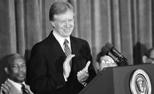 FILE - President Jimmy Carter pauses during a speech to applaud the U.S. Olympic Committee's stand on the Moscow Olympics, Feb. 1, 1980, in Washington. (AP Photo/Mark Wilson, File)