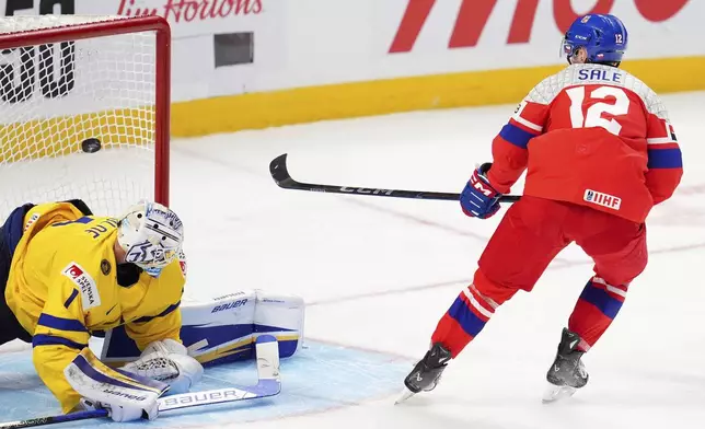 Czechia forward Eduard Sale (12) scores the game-winning goal against Sweden goaltender Marcus Gidlof (1) to win the World Junior hockey championship bronze medal penalty shot shootout, in Ottawa, Sunday, Jan. 5, 2025. (Sean Kilpatrick/The Canadian Press via AP)