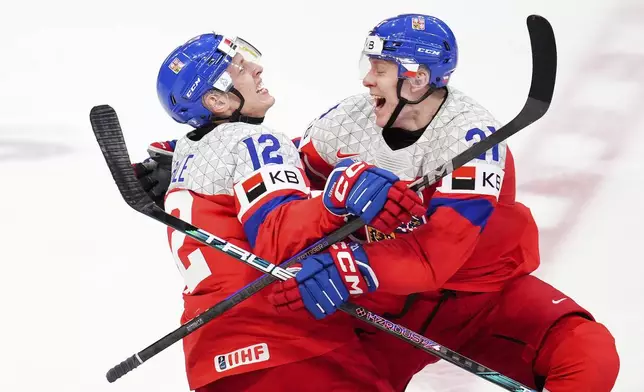 Czechia forward Eduard Sale (12) celebrates his game-winning goal with teammate Czechia forward Jakub Stancl (21) as they win the World Junior hockey championship bronze medal penalty shot shootout against Sweden, in Ottawa, Sunday, Jan. 5, 2025. (Sean Kilpatrick/The Canadian Press via AP)