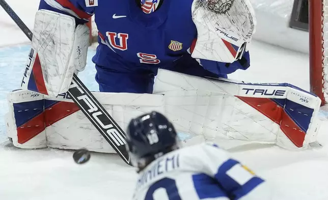 Finland defenseman Emil Pieniniemi (10) fires the puck over United States goaltender Trey Augustine (1) during first-period IIHF World Junior Hockey Championship gold medal game action in Ottawa, Ontario, Sunday, Jan. 5, 2025. (Adrian Wyld/The Canadian Press via AP)