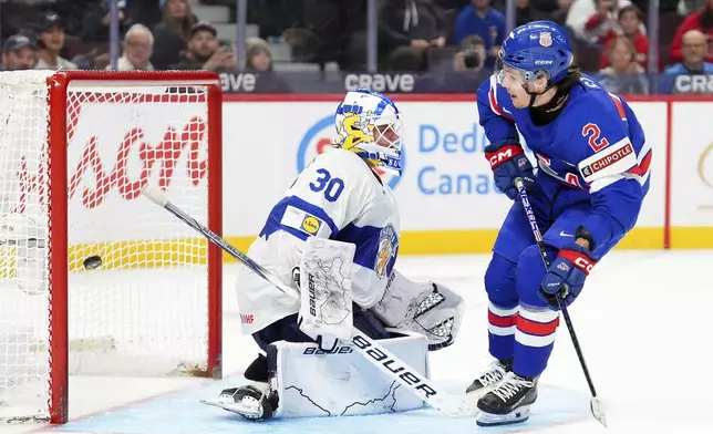 United States’ forward Teddy Stiga (2) scores the game-winning goal on Finland goaltender Petteri Rimpinen (30) to end overtime the IIHF World Junior Hockey Championship gold medal game in Ottawa, Ontario, Sunday, Jan. 5, 2025. (Sean Kilpatrick/The Canadian Press via AP)