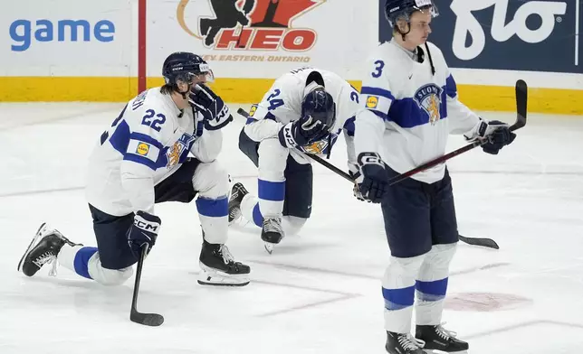 Finland forward Kasper Halttunen (22) with teammates Jesse Nurmi (24) and Kalle Kangas (3) react after their overtime loss to the United States in the IIHF World Junior Hockey Championship gold medal game in Ottawa, Ontario, Sunday, Jan. 5, 2025. (Adrian Wyld/The Canadian Press via AP)