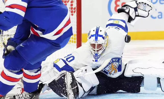 Finland goaltender Petteri Rimpinen, right, makes a save against United States forward Ryan Leonard during third-period IIHF World Junior Hockey Championship gold medal game action in Ottawa, Ontario, Sunday, Jan. 5, 2025. (Sean Kilpatrick/The Canadian Press via AP)