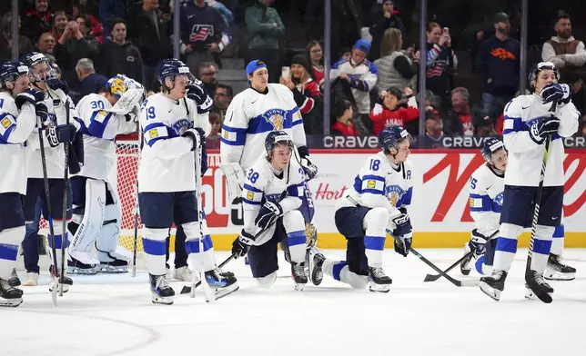 Finland players react following their overtime loss in the IIHF World Junior Hockey Championship gold medal game against the United States in Ottawa, Ontario, Sunday, Jan. 5, 2025. (Sean Kilpatrick/The Canadian Press via AP)