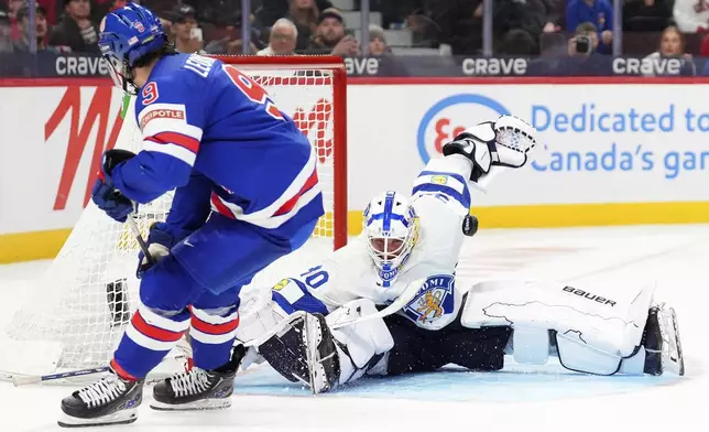 Finland goaltender Petteri Rimpinen (30) makes a save against United States forward Ryan Leonard (9) during third-period IIHF World Junior Hockey Championship gold medal game action in Ottawa, Ontario, Sunday, Jan. 5, 2025. (Sean Kilpatrick/The Canadian Press via AP)