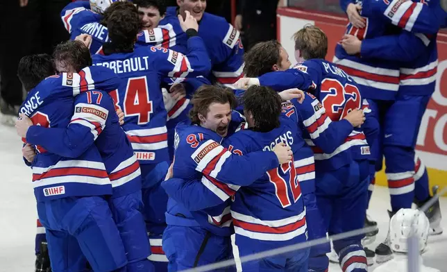 United States players celebrate after their overtime win over Finland in IIHF World Junior Hockey Championship gold medal game action in Ottawa, Ontario, Sunday, Jan. 5, 2025. (Adrian Wyld/The Canadian Press via AP)