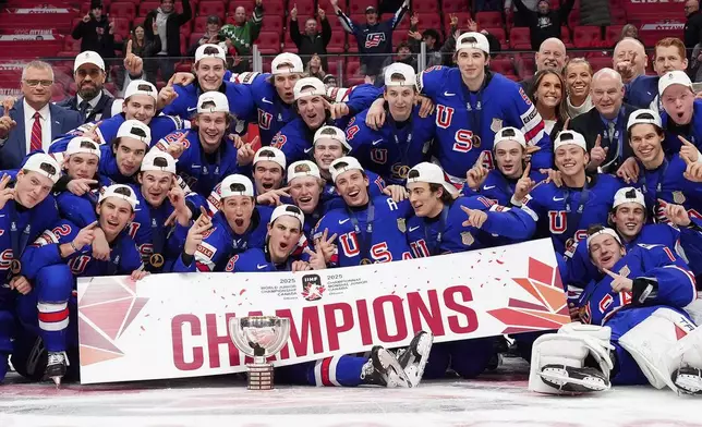 United States players pose for a group photo with the trophy following their IIHF World Junior Hockey Championship gold medal game win over Finland, in Ottawa, Ontario, Sunday, Jan. 5, 2025. (Sean Kilpatrick/The Canadian Press via AP)