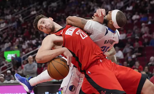 Houston Rockets' Alperen Sengun (28) is fouled by Dallas Mavericks' Daniel Gafford (21) during the first half of an NBA basketball game Wednesday, Jan. 1, 2025, in Houston. (AP Photo/David J. Phillip)