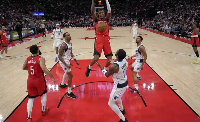 Houston Rockets' Jabari Smith Jr. dunks the ball against the Dallas Mavericks during the first half of an NBA basketball game Wednesday, Jan. 1, 2025, in Houston. (AP Photo/David J. Phillip)