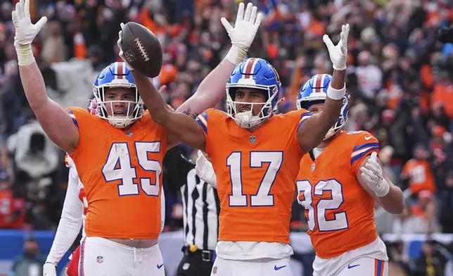 Denver Broncos wide receiver Devaughn Vele (17) celebrates after catching a touchdown pass during the first half of an NFL football game against the Kansas City Chiefs Sunday, Jan. 5, 2025, in Denver. (AP Photo/David Zalubowski)