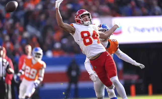 Kansas City Chiefs wide receiver Justin Watson (84) is unable to catch a pass as Denver Broncos cornerback Riley Moss (21) defends during the first half of an NFL football game Sunday, Jan. 5, 2025, in Denver. (AP Photo/David Zalubowski)