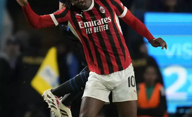 Inter Milan's Matteo Darmian, back, challenges AC Milan's Rafael Leao during the Italian Super Cup final soccer match between AC Milan and Inter Milan at Al Awwal Park Stadium in Riyadh, Saudi Arabia, Monday, Jan. 6, 2025. (AP Photo/Altaf Qadri)