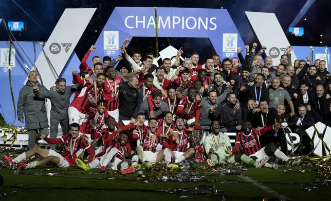 AC Milan's team celebrates after winning the Italian Super Cup final soccer match between AC Milan and Inter Milan at Al Awwal Park Stadium in Riyadh, Saudi Arabia, Monday, Jan. 6, 2025. (AP Photo/Altaf Qadri)