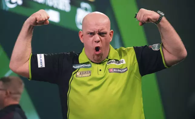 Michael van Gerwen of the Netherlands celebfartes after winning the semifinal match against Chris Dobey of England, at the World Darts Championship in London, Thursday, Jan. 2, 2025. (AP Photo/Kirsty Wigglesworth)