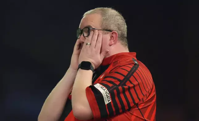 Stephen Bunting of England reacts during the semifinal match against Luke Littler of England, at the World Darts Championship in London, Thursday, Jan. 2, 2025. (AP Photo/Kirsty Wigglesworth)