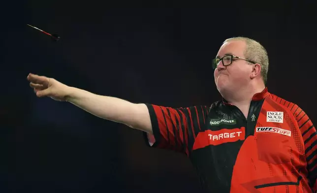 Stephen Bunting of England throws his dart during the semifinal match against Luke Littler of England, at the World Darts Championship in London, Thursday, Jan. 2, 2025. (AP Photo/Kirsty Wigglesworth)