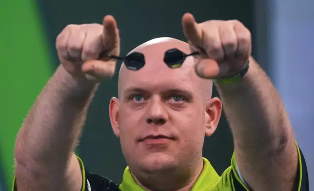 Michael van Gerwen of the Netherlands celebfartes after winning the semifinal match against Chris Dobey of England, at the World Darts Championship in London, Thursday, Jan. 2, 2025. (AP Photo/Kirsty Wigglesworth)