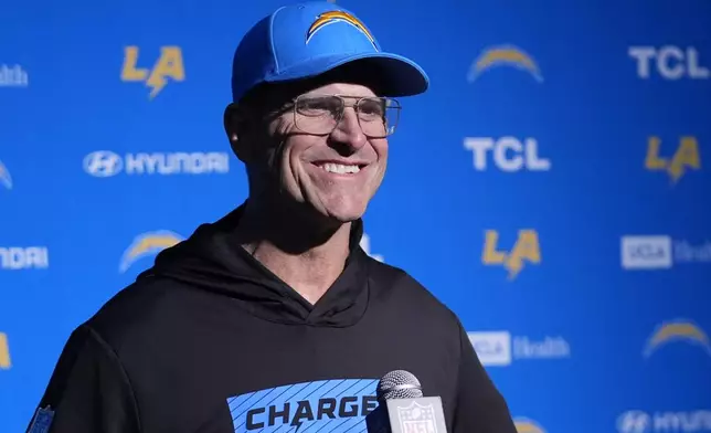 Los Angeles Chargers head coach Jim Harbaugh listens to a reporter's question during a news conference following an NFL football game, Saturday, Dec. 28, 2024, in Foxborough, Mass. (AP Photo/Robert F. Bukaty)