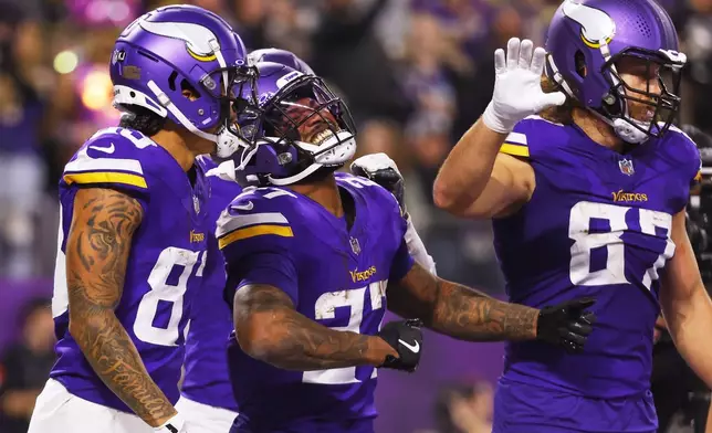 Minnesota Vikings' Cam Akers celebrates his touchdown catch during the second half of an NFL football game against the Green Bay Packers Sunday, Dec. 29, 2024, in Minneapolis. (AP Photo/Bruce Kluckhohn)