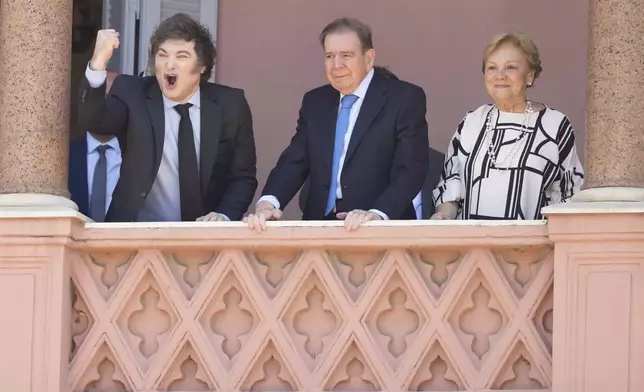 Venezuela's opposition leader Edmundo Gonzalez Urrutia, center, his wife Mercedes Lopez, right, and Argentine President Javier Milei stand at the balcony of the government house in Buenos Aires, Argentina, Saturday, Jan. 4, 2025. Gonzalez, who claims he won the 2024 presidential election and is recognized by some countries as the legitimate president-elect, traveled from exile in Madrid to Argentina. (AP Photo/Natacha Pisarenko)