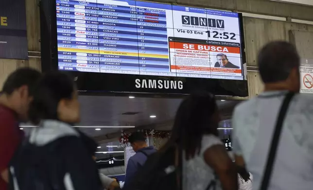 A wanted sign of Venezuelan opposition leader Edmundo Gonzalez is displayed on the list of departure flights at the Simon Bolivar International Airport in Maiquetia, near Caracas, Venezuela, Friday, Jan. 3, 2025. (AP Photo/Cristian Hernandez)