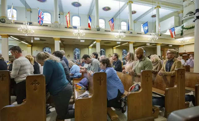 Parishioners pray at St. Louis Cathedral during a mass by Father Patrick Williams about the victims of the New Year's Day deadly truck attack and shooting on Bourbon Street not far from the cathedral in the French Quarter in New Orleans, Sunday, Jan. 5, 2025. (AP Photo/Matthew Hinton)