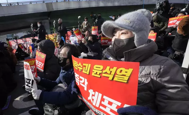 Protesters attend a rally demanding the arrest of impeached South Korean President Yoon Suk Yeol near the presidential residence in Seoul, South Korea, Thursday, Jan. 9, 2025. The letters read "Arrest Yoon Suk Yeol." (AP Photo/Ahn Young-joon)