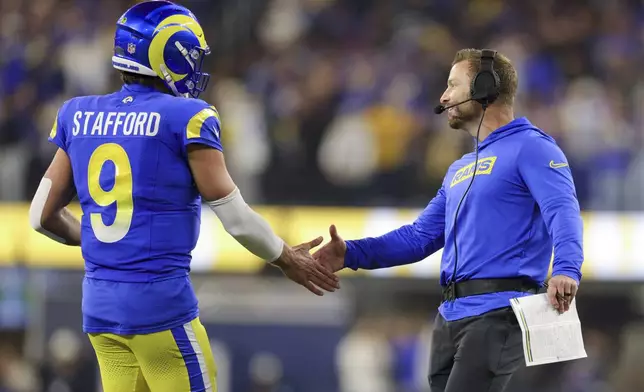 Los Angeles Rams quarterback Matthew Stafford (9) celebrates his team's rushing touchdown with head coach Sean McVay during the first half of an NFL football game Saturday, Dec. 28, 2024, in Inglewood, Calif. (AP Photo/Ryan Sun)