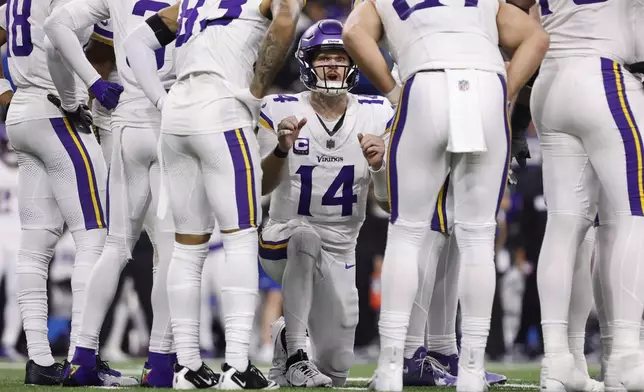 Minnesota Vikings quarterback Sam Darnold (14) calls a play during the second half of an NFL football game against the Detroit Lions, Sunday, Jan. 5, 2025, in Detroit. (AP Photo/Rey Del Rio)