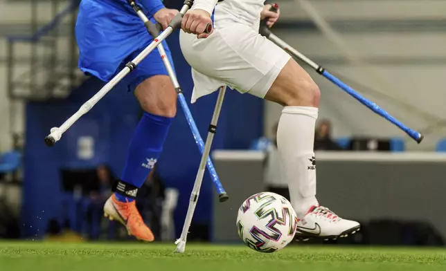 Soccer players of Pokrova FC and Pokrova FC-2 play during the first football tournament for war-wounded amputees in Kyiv, Ukraine, Jan. 11, 2024. (AP Photo/Evgeniy Maloletka)