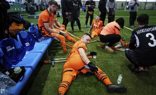 Soccer players of Shakhtar Stalevi rest during Ukraine's first soccer tournament for war-wounded amputees in Kyiv, Ukraine, Jan. 11, 2024. (AP Photo/Evgeniy Maloletka)