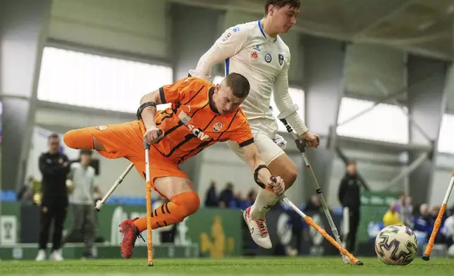 Soccer players of Shakhtar Stalevi and Pokrova FC-2 play during the first football tournament for war-wounded amputees in Kyiv, Ukraine, Jan. 12, 2024. (AP Photo/Evgeniy Maloletka)