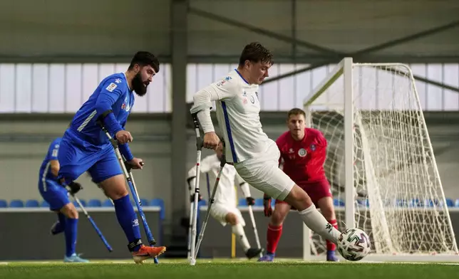 Soccer players of Pokrova FC and Pokrova FC-2 play during the first Ukrainian football tournament for war-wounded amputees in Kyiv, Ukraine, Jan. 11, 2025. (AP Photo/Evgeniy Maloletka)