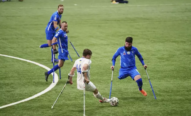 Soccer players of Pokrova FC and Pokrova FC-2 play during the first Ukrainian football tournament for war-wounded amputees in Kyiv, Ukraine, Jan. 11, 2025. (AP Photo/Evgeniy Maloletka)