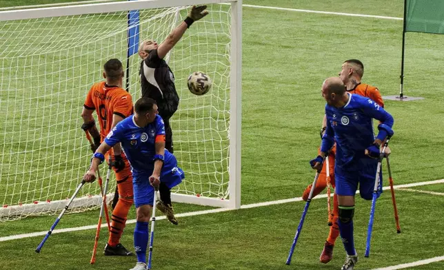 Soccer players of Shakhtar Stalevi and Pokrova FC play during the first football tournament for war-wounded amputees in Kyiv, Ukraine, Jan. 12, 2025. (AP Photo/Evgeniy Maloletka)