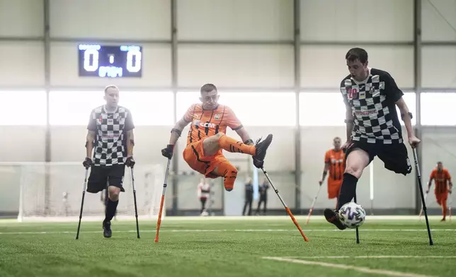 Soccer players of Shakhtar Stalevi and MSK Dnipro play during Ukraine's first soccer tournament for war-wounded amputees in Kyiv, Ukraine, Jan. 11, 2025. (AP Photo/Evgeniy Maloletka)