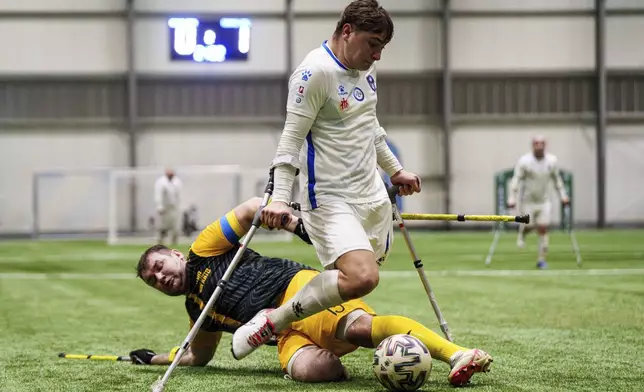 Soccer players of AMP FC Kyiv and Pokrova FC-2 play during the first football tournament for war-wounded amputees in Kyiv, Ukraine, Jan. 12, 2025. (AP Photo/Evgeniy Maloletka)
