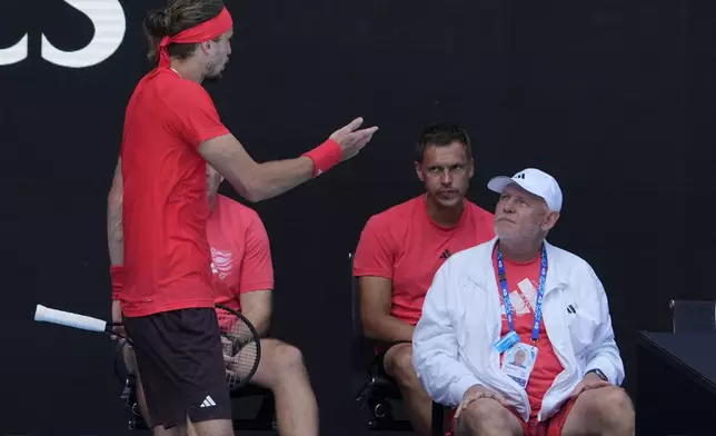 Alexander Zverev of Germany gestures as he talks to his support staff in the coaches box during his quarterfinal match against Tommy Paul of the U.S. at the Australian Open tennis championship in Melbourne, Australia, Tuesday, Jan. 21, 2025. (AP Photo/Asanka Brendon Ratnayake)