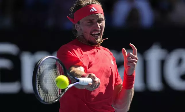 Alexander Zverev of Germany plays a forehand return to Tommy Paul of the U.S. during their quarterfinal match at the Australian Open tennis championship in Melbourne, Australia, Tuesday, Jan. 21, 2025. (AP Photo/Vincent Thian)