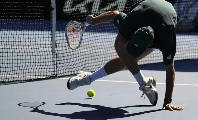 Tommy Paul of the U.S. plays a backhand return to Alexander Zverev of Germany during their quarterfinal match at the Australian Open tennis championship in Melbourne, Australia, Tuesday, Jan. 21, 2025. (AP Photo/Vincent Thian)